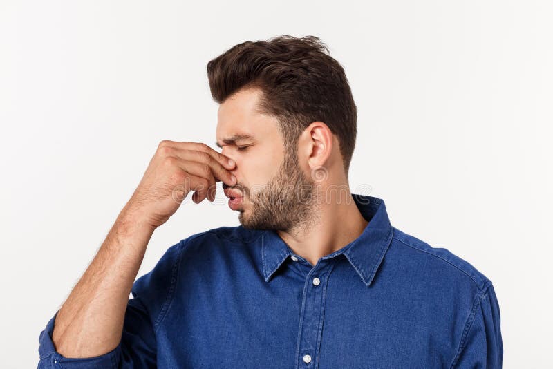 Man holding his nose against a bad smell isolated over grey background. royalty free stock photo Man holding his nose against a bad smell isolated over grey background. royalty free stock photo