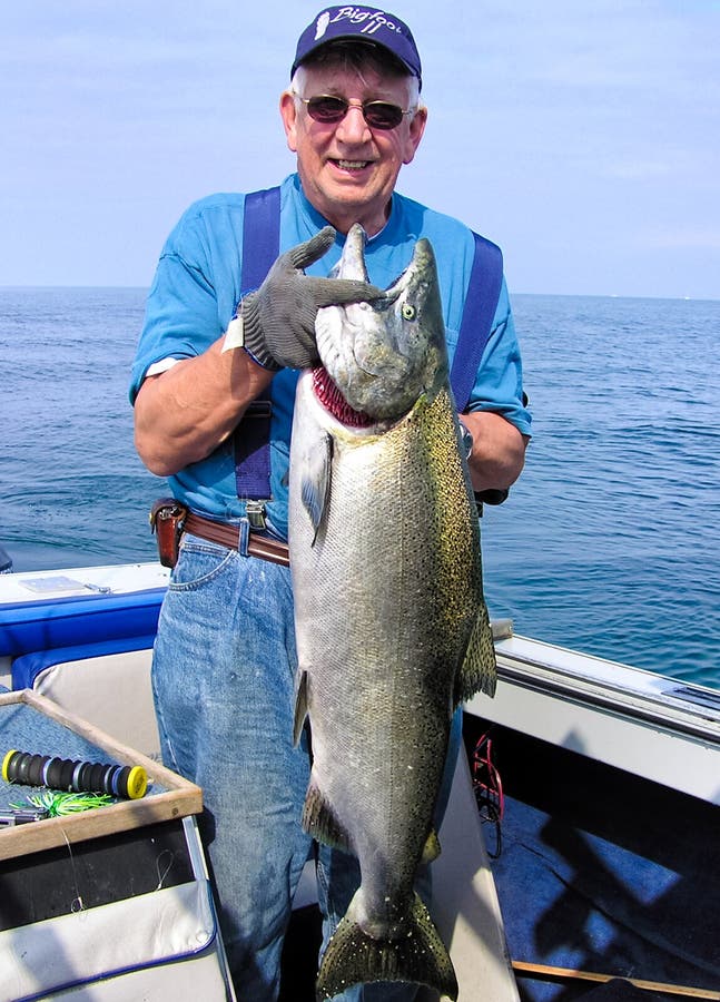 Man Holding Large Fish - Lake Ontario King Salmon stock photos Man Holding Large Fish - Lake Ontario King Salmon stock photos