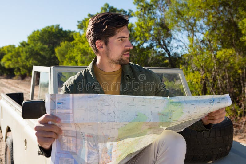Man holding map on off road vehicle