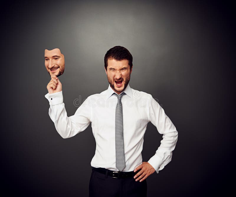 Man holding mask with smiley face