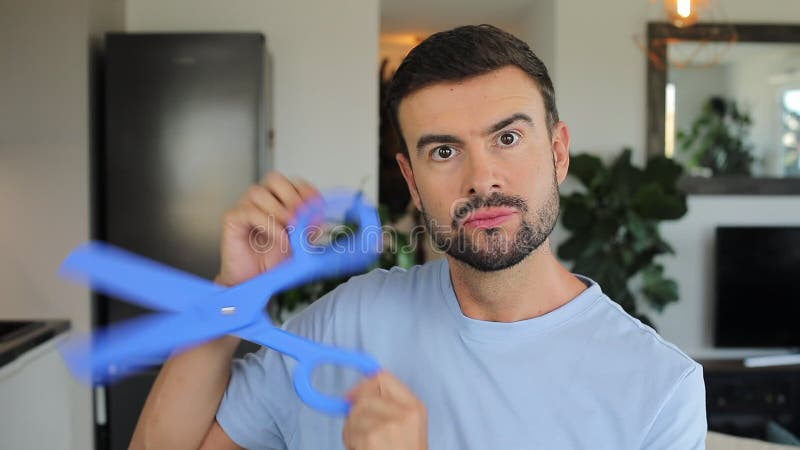 Man holding a pair of gigantic blue scissors stock video footage