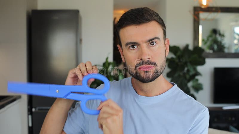 Man holding a pair of gigantic blue scissors stock footage