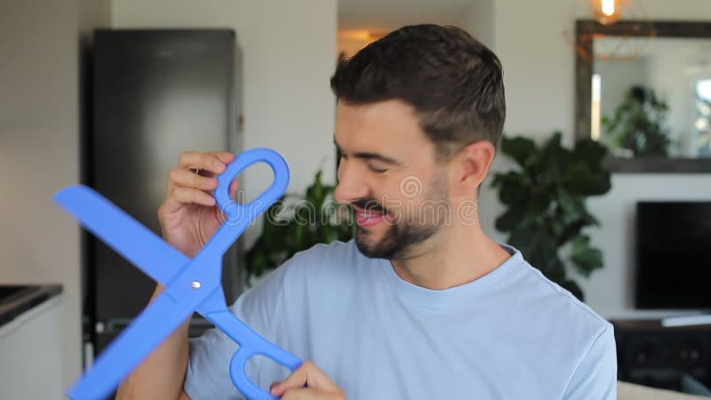 Man holding a pair of gigantic blue scissors stock video footage