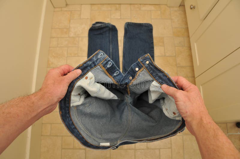 Download Man Holding Pants Before Putting Them On Stock Image - Image: 18075661