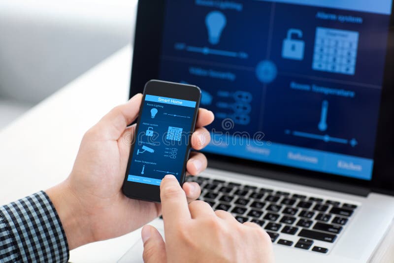 Man holding phone with program smart home on the screen stock photography