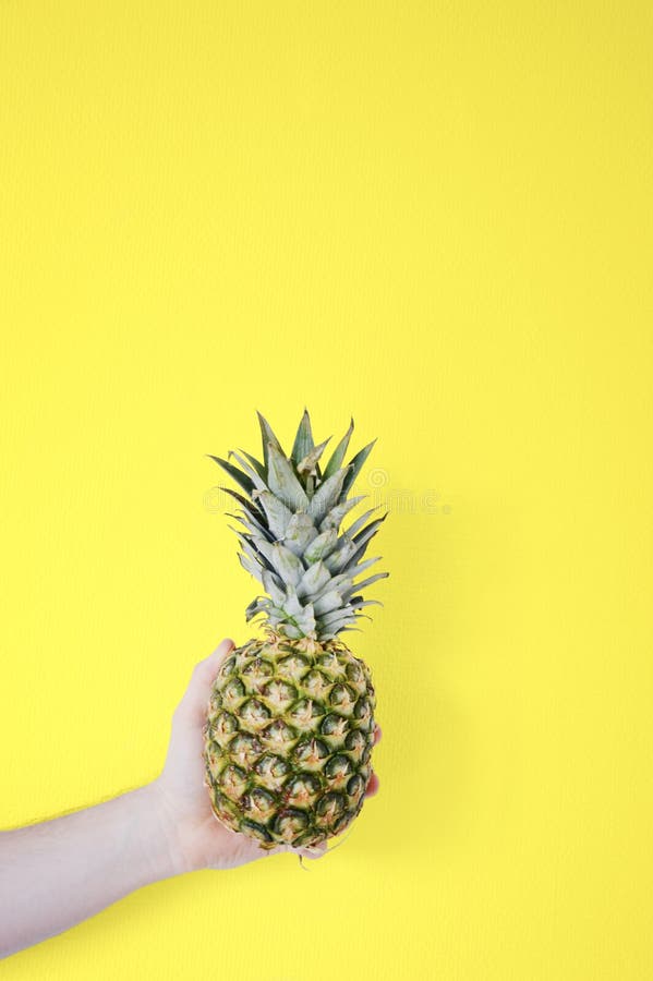 Man Holding Pineapple Against Yellow Background Stock Photo - Image of ...