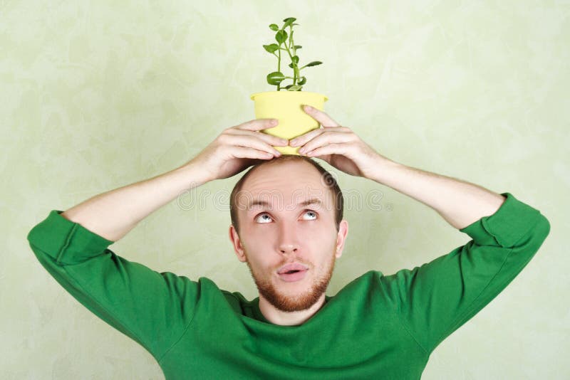 Man holding potted plant on his head