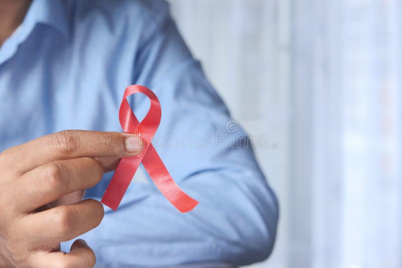 Man holding red HIV ribbon with copy space royalty free stock photo