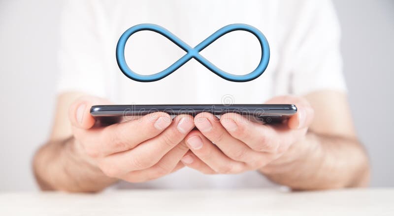 Man holding smartphone with a Infinity symbol royalty free stock photo