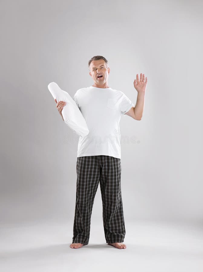 Man holding soft pillow stock photo. Image of mature 123604474
