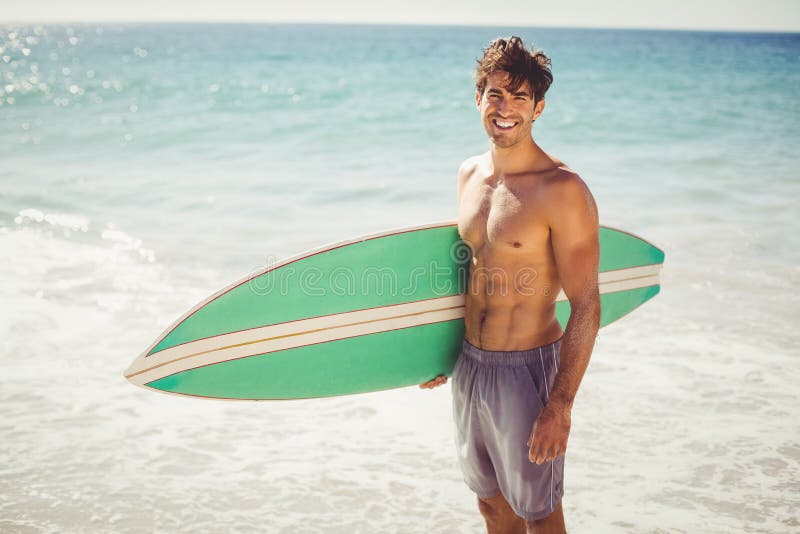 Man Holding Surfboard on Beach Stock Photo Image of handsome, male