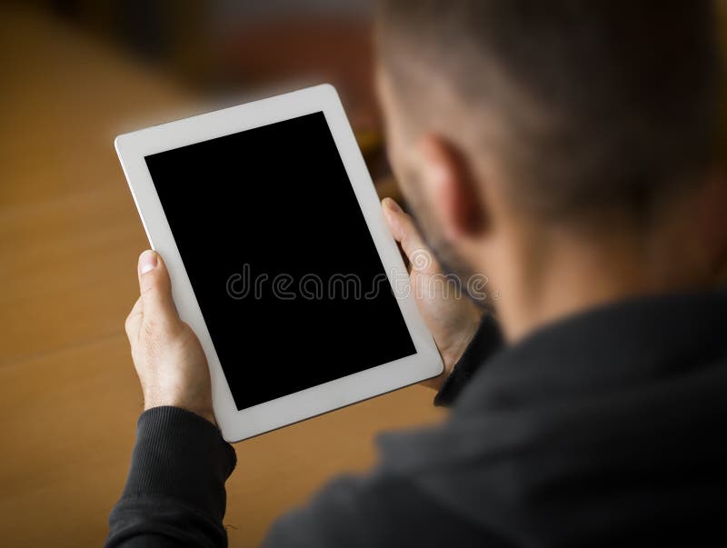 Man holding a tablet with blank screen. Perspective from behind the arm. Male hand holding businessman stock images, royalty-free photos and pictures