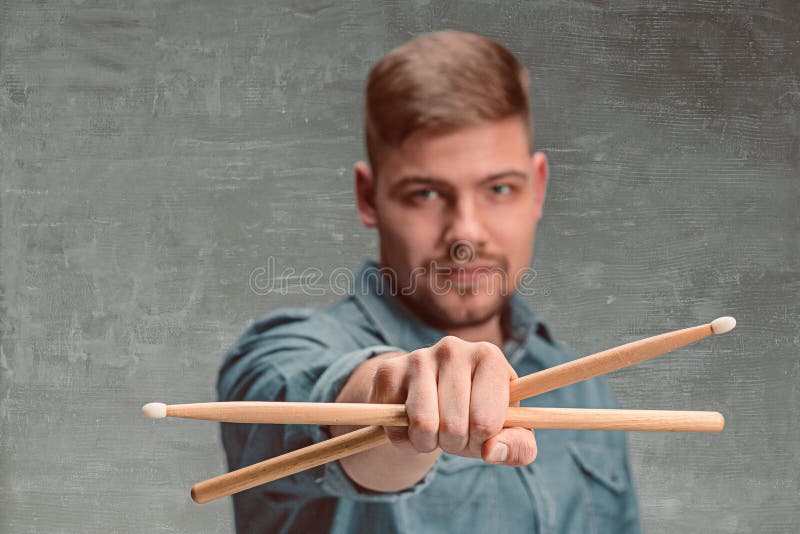 Man Holding Two Drumsticks Over Gray Background Stock Photo Image of