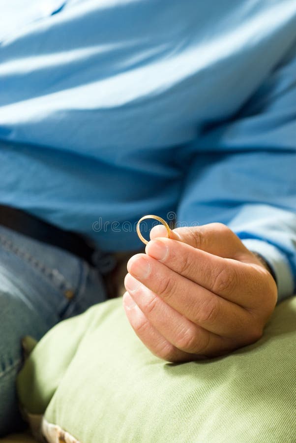 Man Holding Wedding Band - Vertical