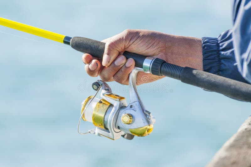 Download Man Holding Yellow Fishing Rod Stock Image - Image of hand ...