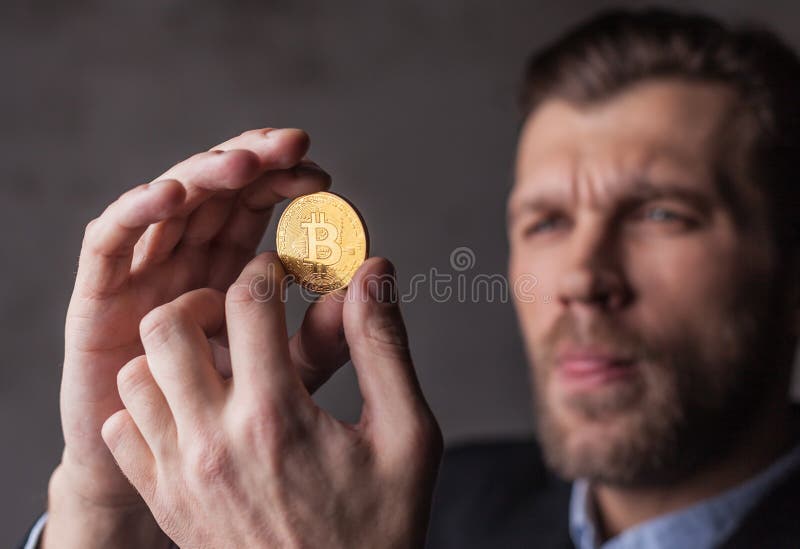 Man holds bitcoin in hands stock image. Image of business - 106006081