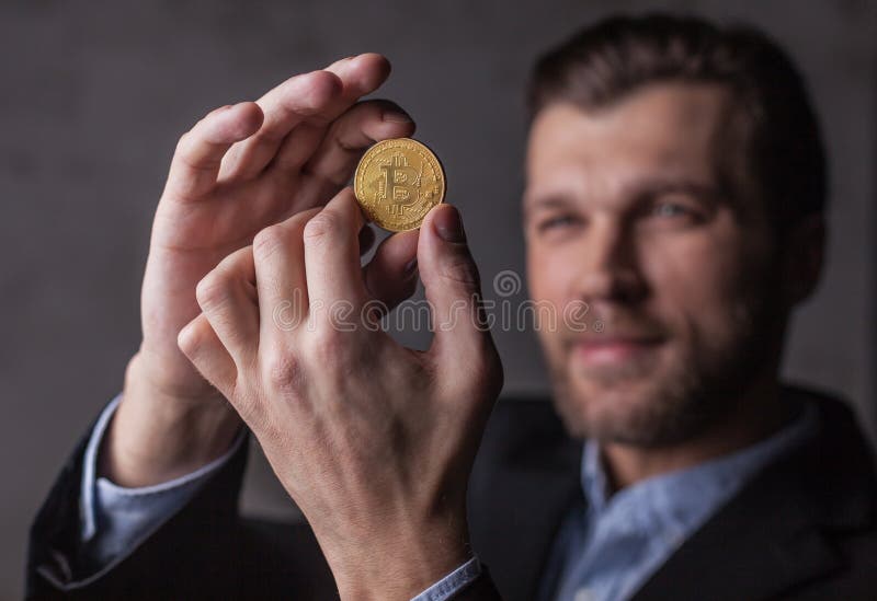 Man holds bitcoin in hands stock image. Image of growth - 106005983