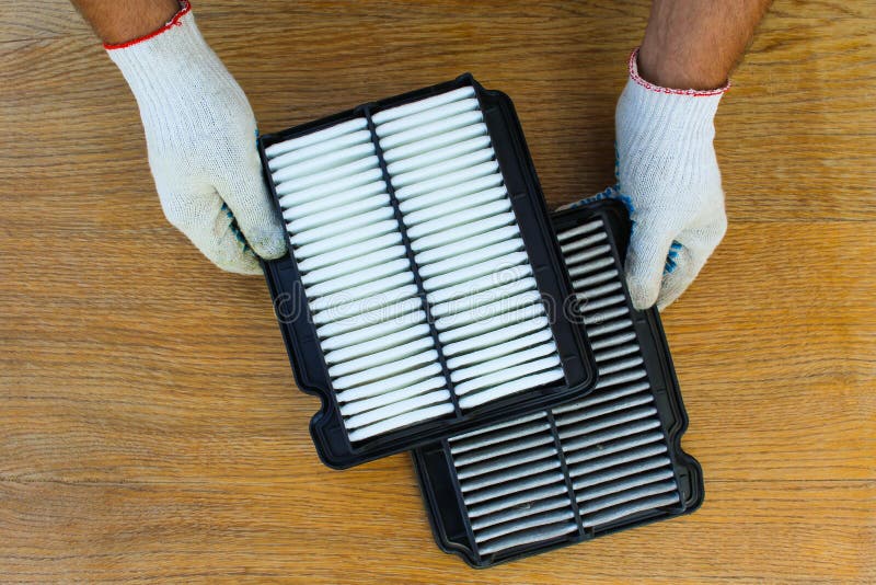 Man Holds Clean and Dirty Filters on Car. Stock Image Image of