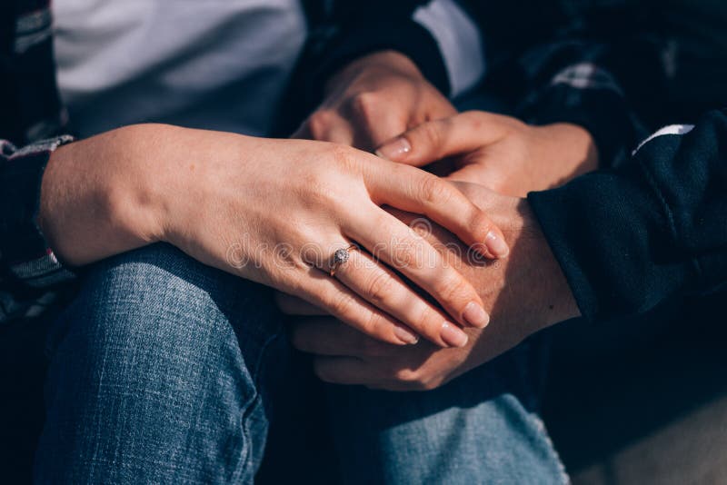Man Holds Hand of His Beloved with a Wedding Ring on His Finger Stock