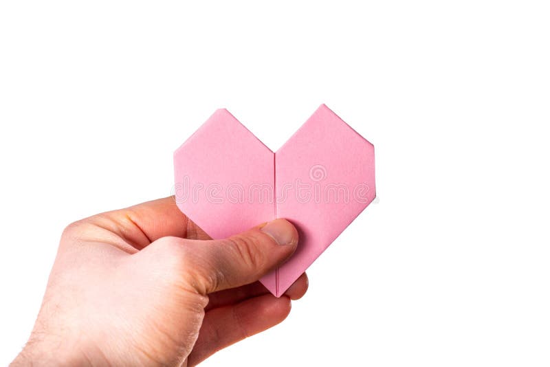 Man holds a heart made out of paper on white background stock photo