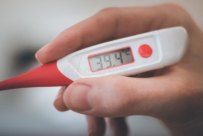 Man is Holding a Fever Thermometer in His Hand Stock Image -