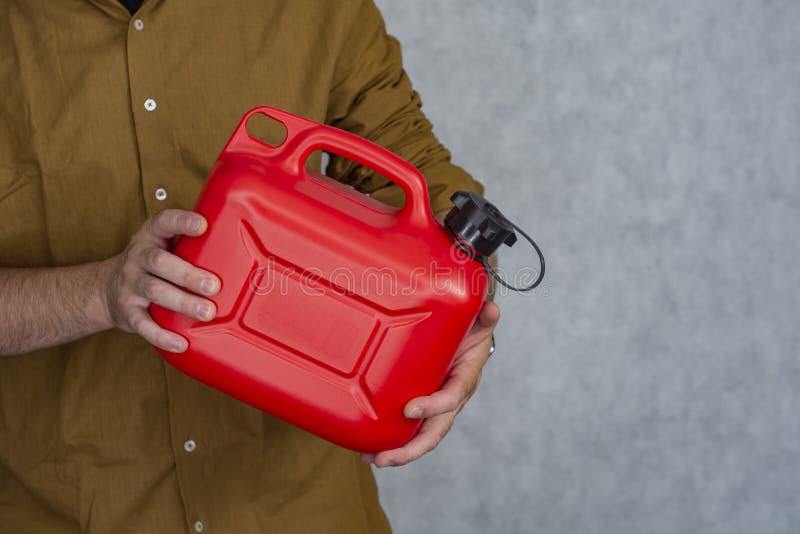 Man Holds a Red Plastic Gas Canister in His Hands Stock Image Image