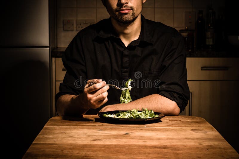 Man at home having dinner royalty free stock photography Man at home having dinner royalty free stock photography