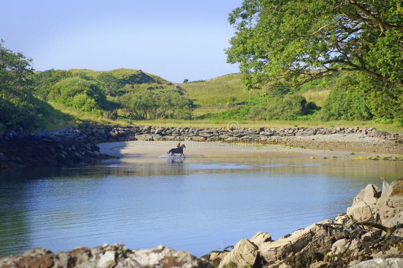 Man on horse at beach in Killybegs, West Ireland