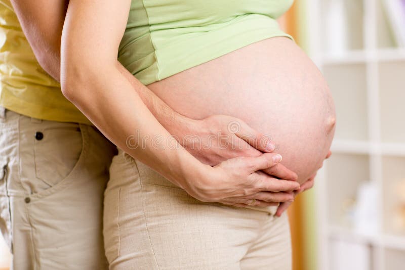 Man hugging his pregnant wife royalty free stock photography Man hugging his pregnant wife royalty free stock photography