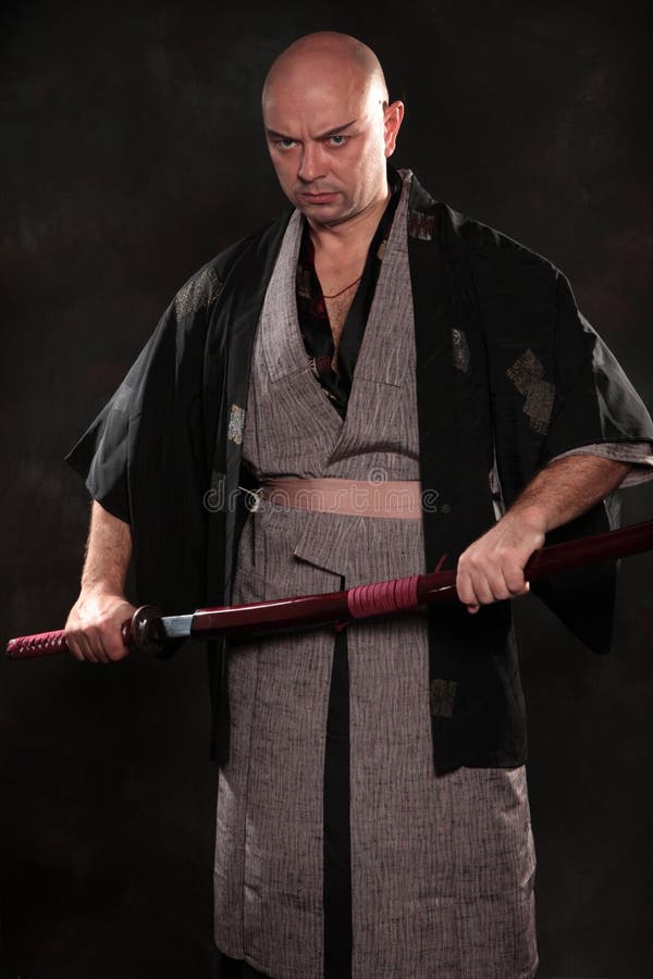 A Man, In A Black Kimono Is Practicing Martial Arts Technique With A Long  Bamboo Fighting Stick. Stock Photo, Picture and Royalty Free Image. Image  91980191.