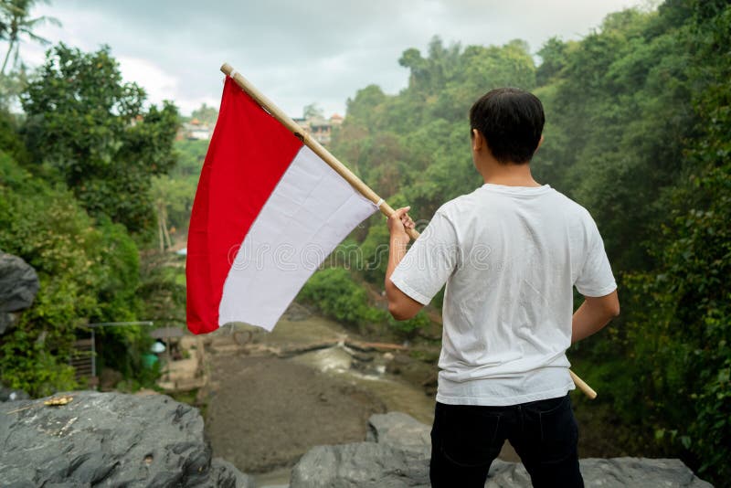 Man with Indonesian Flag of Indonesia on Top of the Mountain Stock ...