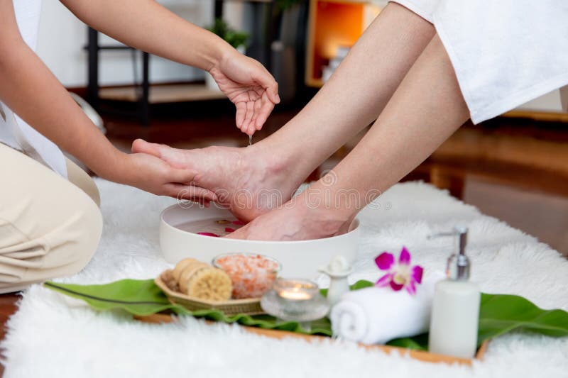 Man indulges in blissful foot massage at luxurious spa salon. Quiescent