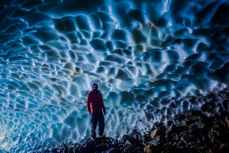 Man inside an ice cave stock images
