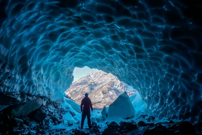 Man inside an ice cave royalty free stock images