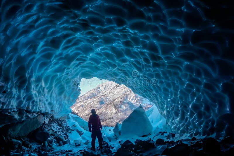Man inside an ice cave royalty free stock images