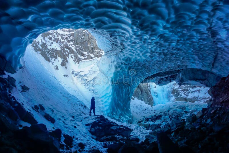 Man inside an ice cave royalty free stock photo