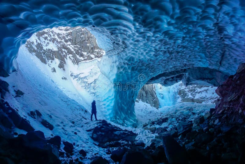 Man inside an ice cave royalty free stock photos