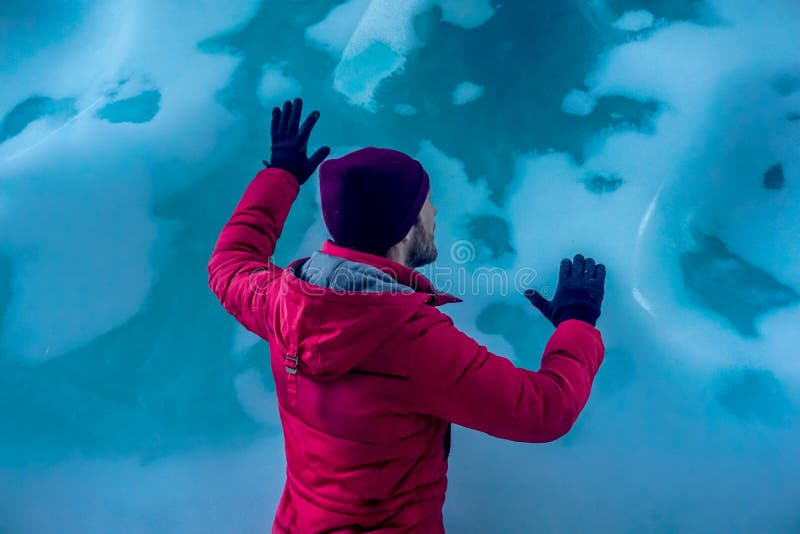 Man inside an ice cave royalty free stock images