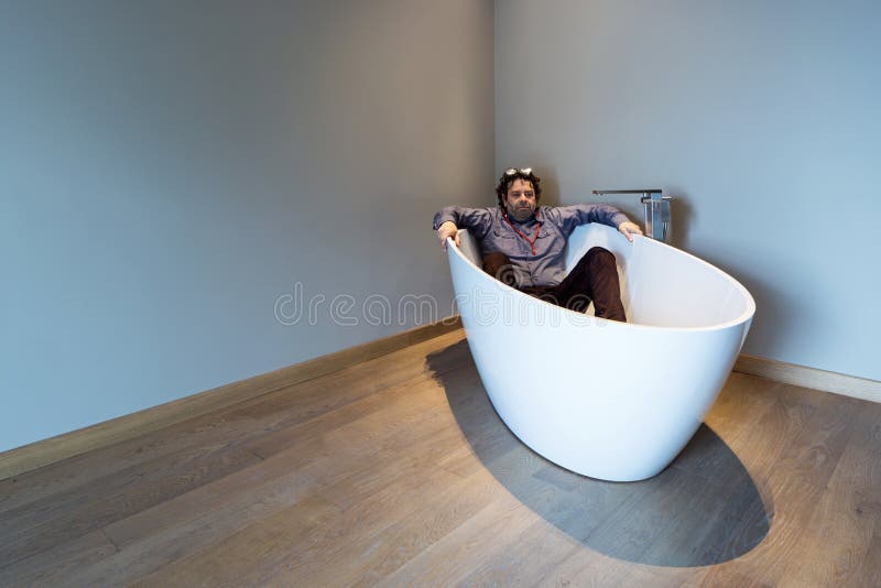 Man inside a luxury bathtub in modern apartment stock image Man inside a luxury bathtub in modern apartment stock image