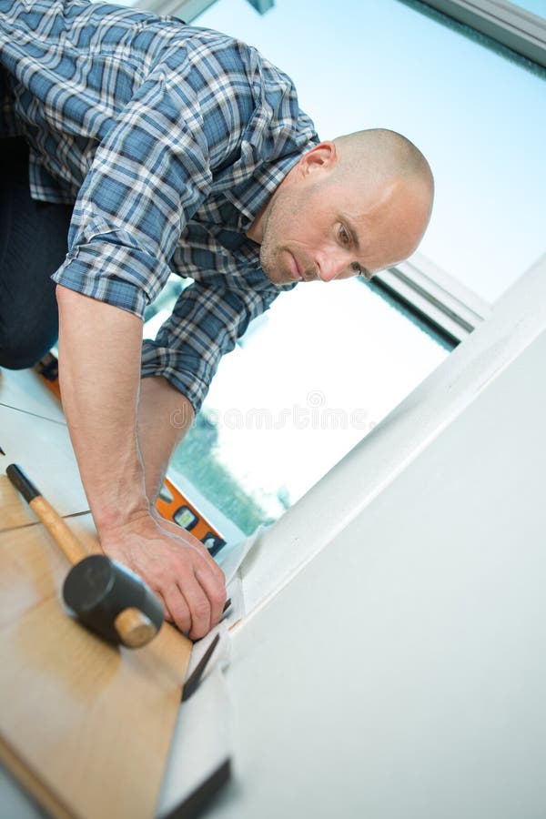 Guy in Red Installing Flooring Stock Photo Image of renovation