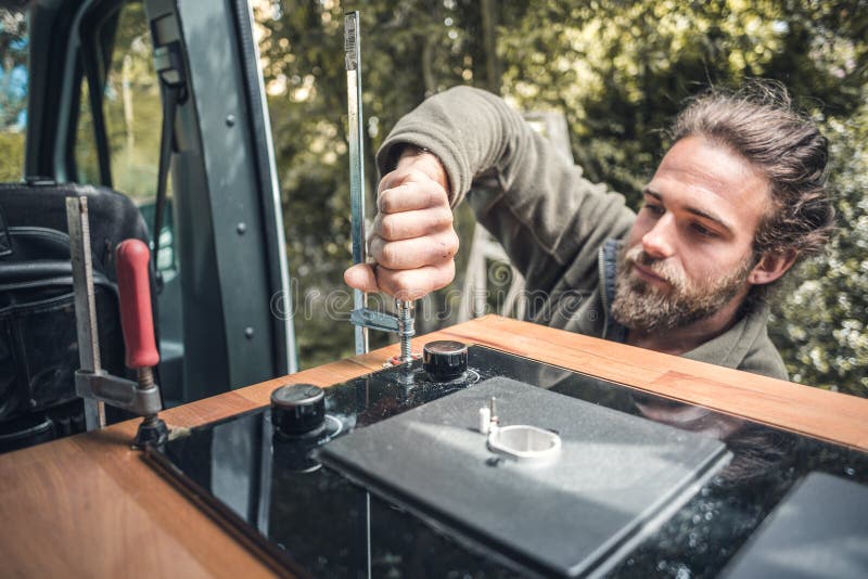 Man Installing a Gas Stove into a Camper Van Stock Image Image of