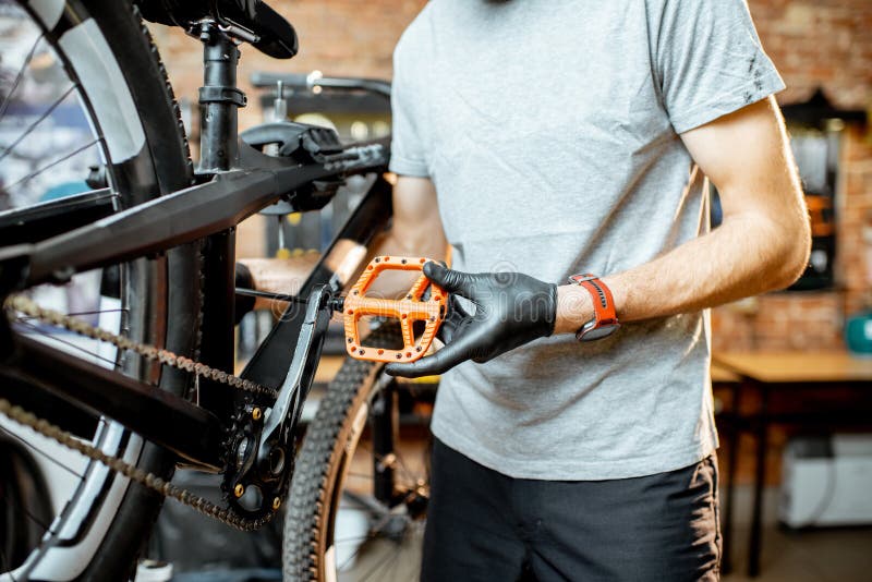 Man Installing New Pedals on a Bicycle Stock Photo Image of