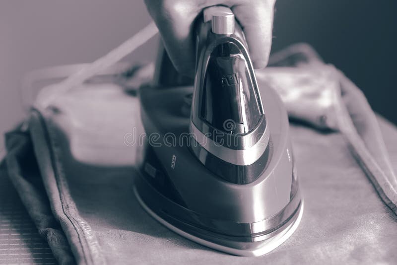 Man Ironing Denim Jeans with an Electric Iron Stock Photo Image of
