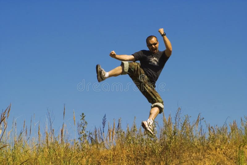 Man jumping on a meadow royalty free stock photo