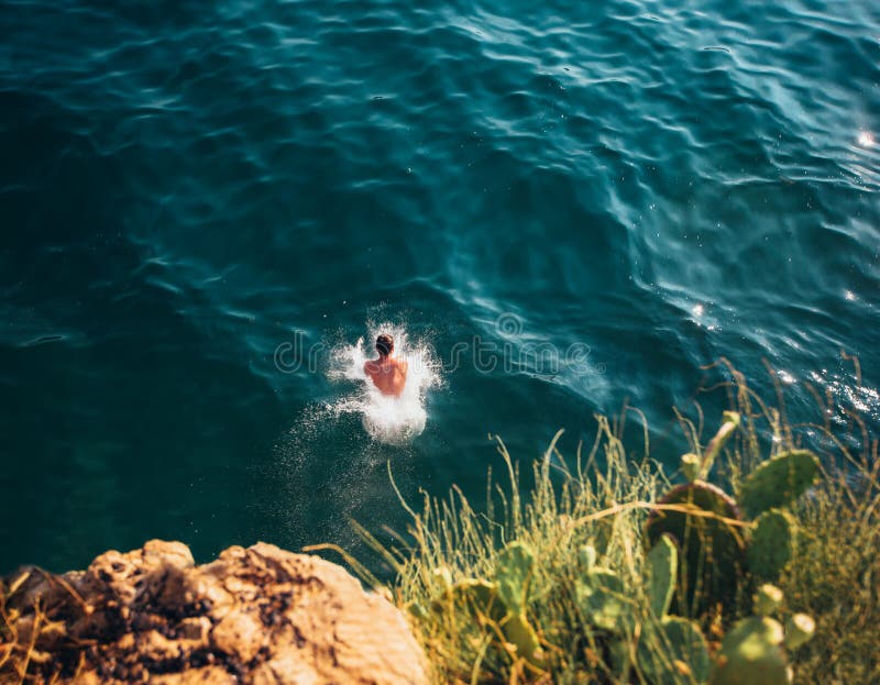 Girl Jumping Off Cliff Blue Water Stock Photos - Free & Royalty-Free ...