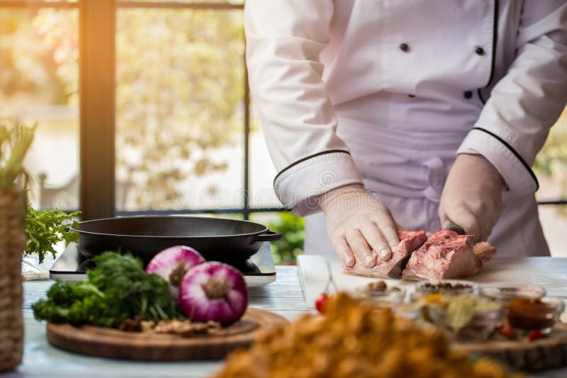 Man with knife cuts meat.