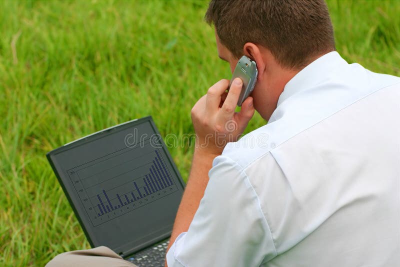 Man with laptop sitting in grass royalty free stock image Man with laptop sitting in grass royalty free stock image