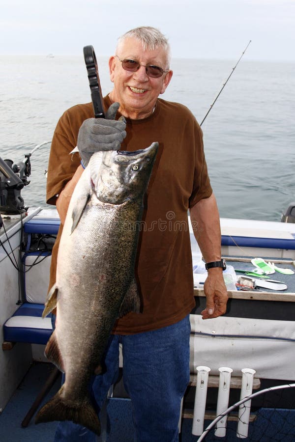 Man with Large Fish - King Salmon royalty free stock images Man with Large Fish - King Salmon royalty free stock images