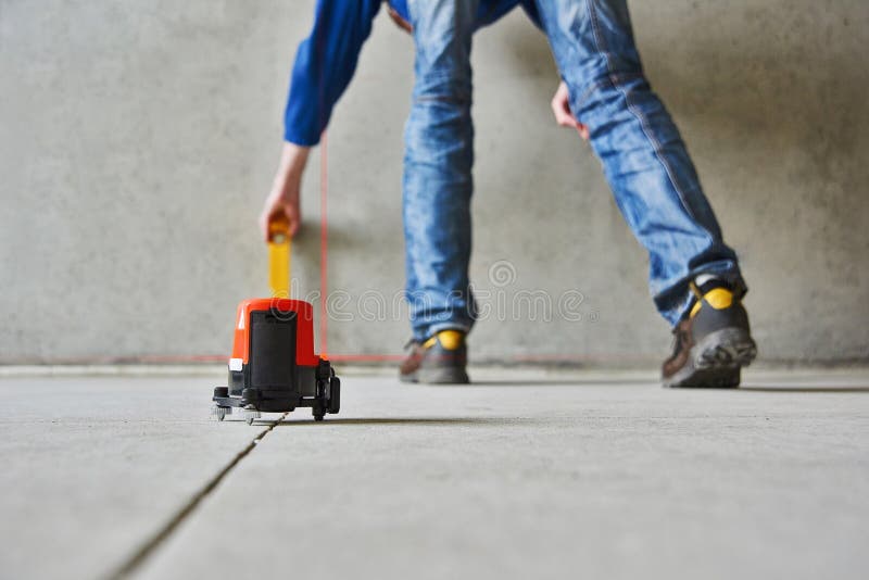 Man with laser level check floor and walls royalty free stock photo Man with laser level check floor and walls royalty free stock photo