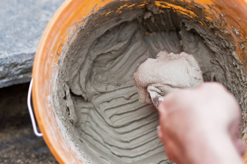 Man Laying on Cement Mixed in a Bucket Stock Image Image of rustic